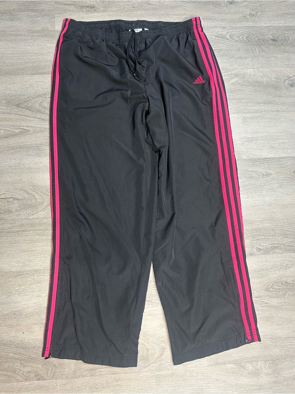 Adidas woman’s black wide leg track pants with pink stripes, size XL